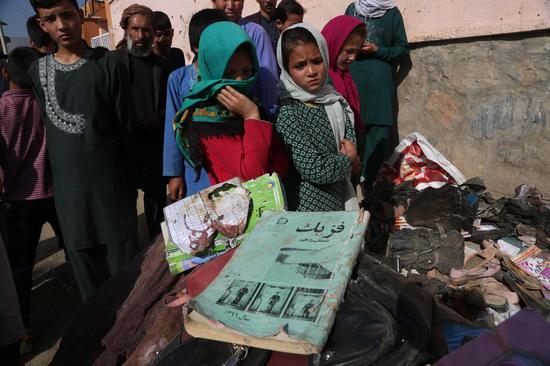 Photo taken on May 9, 2021 shows the books of students who were killed in a car bomb attack in Kabul, capital of Afghanistan. (Photo by Rahmatullah Alizadah/Xinhua)