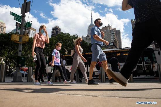 People walk along the Street in New York, the United States, June 15, 2021. New York State Governor Andrew Cuomo Tuesday announced the immediate lifting of major COVID-19 restrictions across the state as 70 percent of adults in the state have received at least one dose of COVID-19 vaccine. (Xinhua/Michael Nagle)