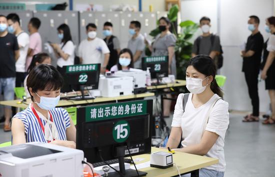 A staff worker registers information of COVID-19 vaccine recipients in the inoculation site of the Guangyi International E-Commerce Industrial Park in Haizhu District of Guangzhou, south China's Guangdong Province, June 19, 2021. (Xinhua/Wang Ruiping)