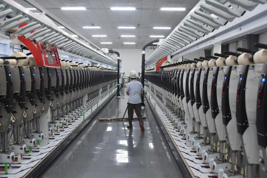 An automatic production line is seen at a textile plant in Shihezi City, northwest China's Xinjiang Uygur Autonomous Region, July 7, 2021. (Xinhua/Gu Yu)