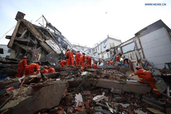Rescuers work at the site of a collapsed building in Suzhou, east China's Jiangsu Province, July 12, 2021. One person died, and another 10 people are missing after a building collapsed Monday in east China's Jiangsu Province, local authorities said. The incident happened at around 3:33 p.m. Monday at a hotel in Wujiang District in the city of Suzhou, the district government said. As of 6:40 p.m., eight people had been rescued, with one dead. Four are in stable condition, and three in critical condition. Rescue efforts are still ongoing, and the cause of the collapse is under investigation. (Xinhua)