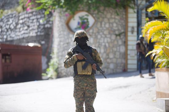 A soldier stands guard in front of Haitian President Jovenel Moise's home in Port-au-Prince, Haiti, on July 7, 2021. (Photo by Tcharly Coutin/Xinhua)