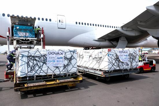 Photo taken on March 5, 2021 shows AstraZeneca-Oxford vaccines from COVAX vaccine sharing program being unloaded from a plane at Entebbe International Airport, Uganda. (Photo by Hajarah Nalwadda/Xinhua)