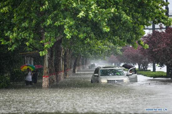 A car is inundated by rainwater in Zhengzhou, capital of central China's Henan Province, July 20, 2021.  (Photo by Hou Jianxun/Xinhua)