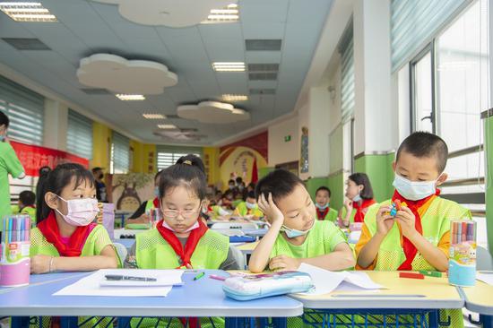 Children have class at a daycare classroom at Qinyuanlu Community of Wuhan, central China's Hubei Province, July 5, 2021. (Photo by Wu Zhizun/Xinhua)