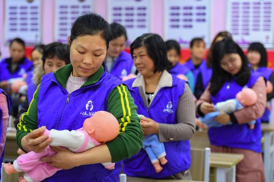 Trainees learn baby nursing skills at a vocational training school in Changsha County of Changsha City, central China's Hunan Province, April 9, 2021. (Xinhua/Chen Zeguo)