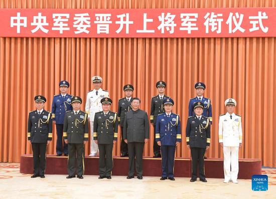 Xi Jinping, chairman of the Central Military Commission (CMC), together with other senior military officials, poses for a group photo with five senior military officers who have been promoted to the rank of general, at a ceremony held by the CMC in Beijing, capital of China, Sept. 6, 2021. Xi presented certificates of order to them at the ceremony. (Xinhua/Li Gang)