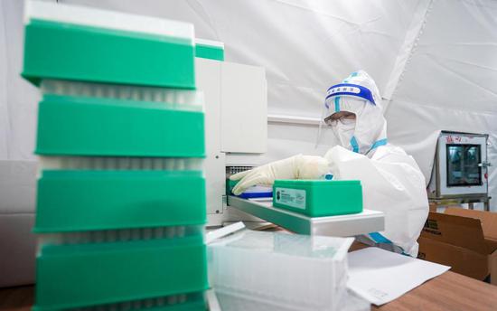 A medical worker operates at a 