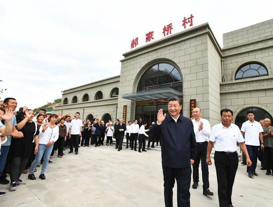 Chinese President Xi Jinping, also general secretary of the Communist Party of China Central Committee and chairman of the Central Military Commission, waves to villagers while visiting a village in Suide, a county under the city of Yulin in northwest China's Shaanxi Province, Sept. 14, 2021. (Xinhua/Xie Huanchi)