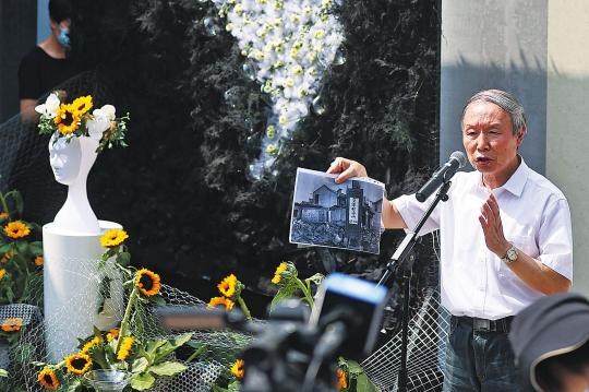 Su Zhiliang, a professor at Shanghai Normal University, displays evidence at an exhibition on Saturday in Nanjing, Jiangsu province, of the monstrous crimes of forced recruitment of 