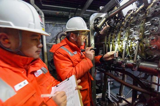 Maintenance workers are on patrol inspection at the Horgos initial compressor station of the West Pipeline Company under China Oil & Gas Pipeline Network Corporation (PipeChina) in Horgos, northwest China's Xinjiang Uygur Autonomous Region, Feb. 4, 2021. (Xinhua/Ding Lei)