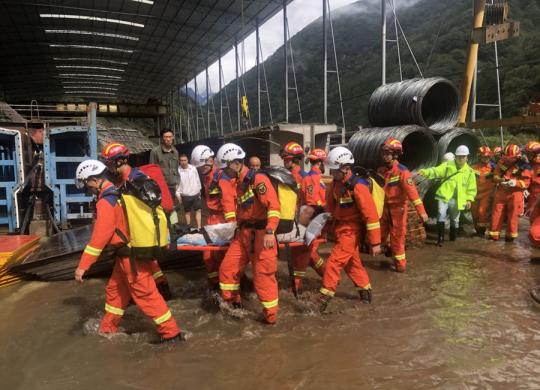 Rescue team members transfer a person once trapped by mudslide in Tianquan county, Southwest China's Sichuan province, Sept 26, 2021. (Photo/Xinhua)