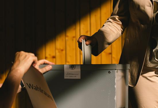 A voter casts a ballot at a polling station in Cologne, Germany, Sept. 26, 2021. (Photo by Tang Ying/Xinhua)