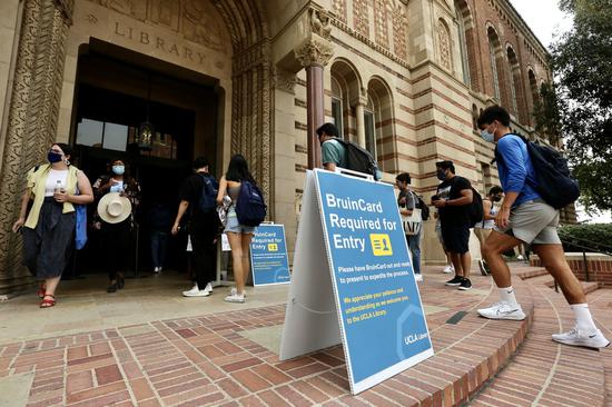 Students are seen at the entrance of the Library on campus of the University of California, Los Angeles (UCLA), in Los Angeles, the United States, Sept. 23, 2021. (Xinhua)