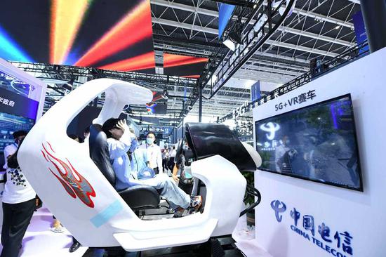 A visitor experiences a 5G+VR racing cockpit at the China International Digital Economy Expo 2021 in Shijiazhuang, North China's Hebei province, Sept 7, 2021. (Photo/Xinhua)