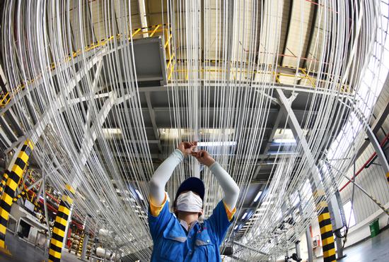 A worker checks the operation of a carbon fiber production line at a factory in Lianyungang, Jiangsu province. (Photo : China Daily/Geng Yuhe)