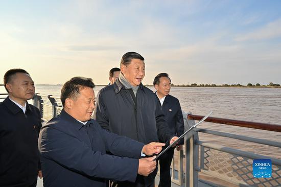 Chinese President Xi Jinping, also general secretary of the Communist Party of China Central Committee and chairman of the Central Military Commission, checks the Yellow River's waterways and learns about the ecological protection and high-quality development of the Yellow River basin at a dock as he inspects the estuary of the Yellow River in the city of Dongying, east China's Shandong Province, Oct. 20, 2021. (Xinhua/Li Xueren)