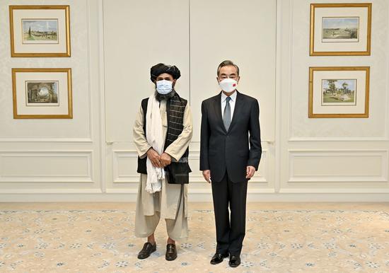 Chinese State Councilor and Foreign Minister Wang Yi (R) meets with Mullah Abdul Ghani Baradar, acting deputy prime minister of the Afghan Taliban's interim government, in Doha, Qatar, on Oct. 25, 2021. (Photo by Nikku/Xinhua)