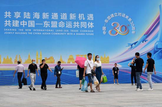 People walk out of the venue of the 18th China-ASEAN Expo in Nanning, capital of south China's Guangxi Zhuang Autonomous Region, Sept. 13, 2021. (Xinhua/Lu Boan)