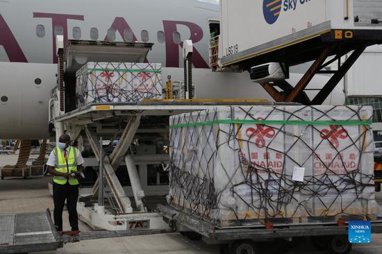A staff member unloads the COVID-19 vaccines from China at Julius Nyerere International Airport in Dar es Salaam, Tanzania, on Nov. 1, 2021. (Photo/Xinhua)