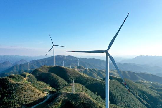 Aerial photo taken on Aug 19, 2020 shows wind turbines in Jiucaiping scenic spot in Southwest China's Guizhou province. (Photo/Xinhua)