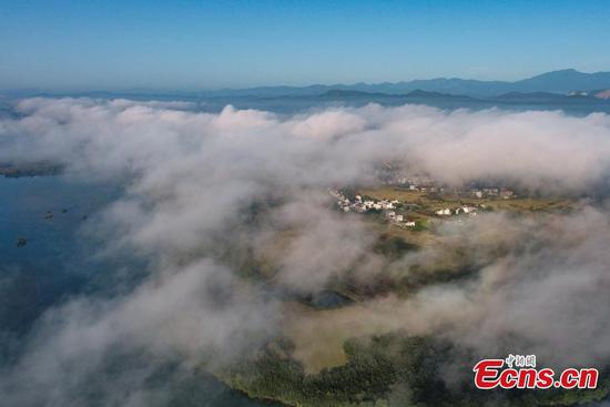 Magnificent clouds and mist hover over township in Jiangxi