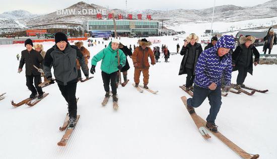 Visitors using fur skis enjoy the snow at Jiangjunshan Ski Resort in Altay prefecture in Xinjiang in 2019. (Photo/China Daily)