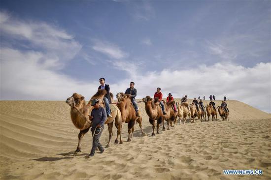 Tourists ride camels in Lop Nur People Village of Yuli county, Northwest China's Xinjiang Uygur autonomous region, Oct 16, 2018. (Photo/Xinhua)