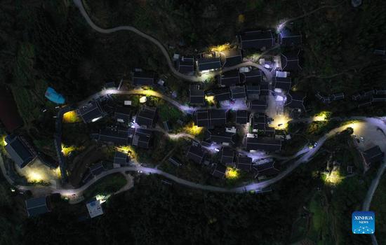 Solar powered street lamps illuminate night sky in south China