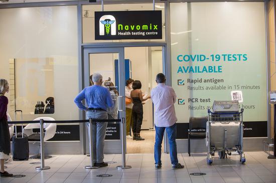Travelers wait to receive COVID-19 tests at Cape Town International Airport in Cape Town, South Africa, Nov. 29, 2021. (Str/Xinhua)