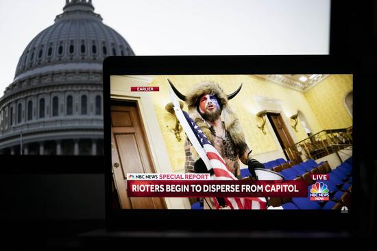 A protester breaking into the U.S. Capitol building is captured on a screenshot in a video feed from NBC news seen in Arlington, Virginia, the United States, Jan. 6, 2021. (Xinhua/Liu Jie)
