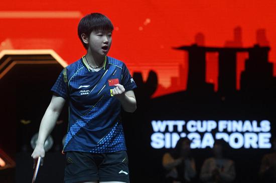 Sun Yingsha reacts during the women's singles finals match against her Chinese compatriot Wang Yidi at the 2021 World Table Tennis (WTT) Cup Finals in Singapore's OCBC Arena on Dec. 7, 2021. (Photo by Then Chih Wey/Xinhua)