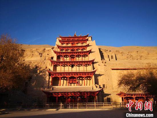 One of the representative buildings of Mogao Grottoes showered by the light of the morning sun. (Photo: China News Service/Feng Zhijun)