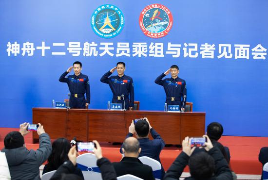 Chinese astronauts Tang Hongbo (L), Nie Haisheng (C) and Liu Boming attend a press conference held by the China Astronaut Research and Training Center in Beijing, capital of China, Dec. 7, 2021. Tang Hongbo, Nie Haisheng and Liu Boming, the three astronauts of the Shenzhou-12 spaceflight mission, on Tuesday met with the public and the press here for the first time after their return to Earth. (Xinhua/Jin Liwang)