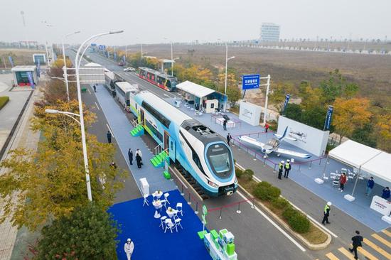 Aerial photo taken on Dec. 8, 2021 shows people viewing the exhibits at China International Rail Transit and Equipment Manufacturing Industry Exposition in Zhuzhou, central China's Hunan Province. (Xinhua/Chen Sihan)