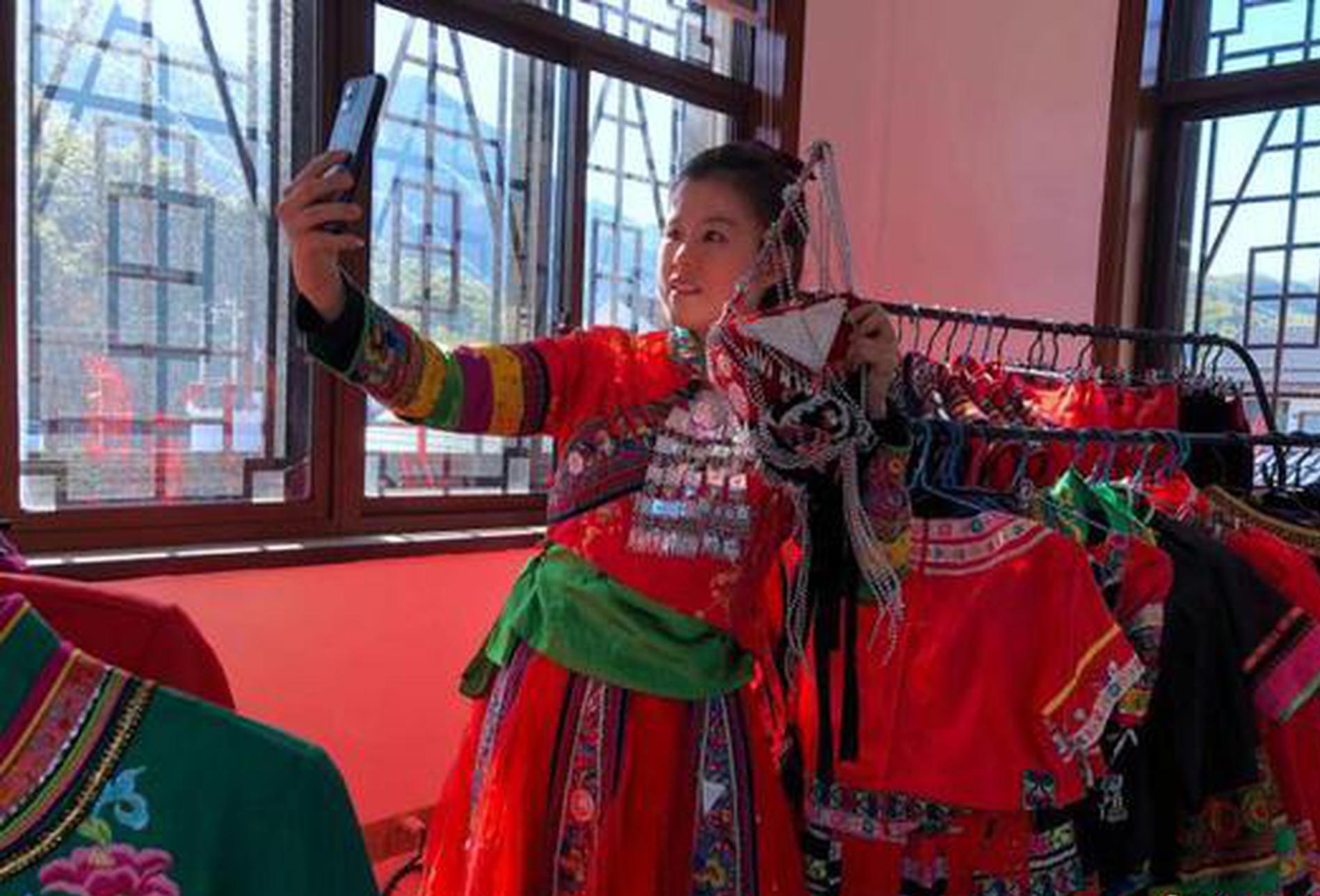 She ethnic craftswoman weaves dream into colored ribbons