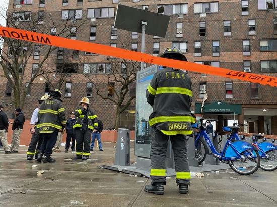 Firefighters are seen in front of the apartment building in Bronx, New York, the United States, on Jan. 9, 2022. (Photo by Michael Nagle/Xinhua)