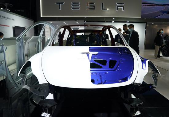 People visit the Tesla exhibition section at the 4th China International Import Expo (CIIE) in Shanghai, east China, Nov. 5, 2021. (Xinhua/Ding Ting)