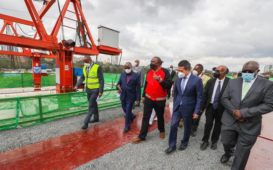 Kenyan President Uhuru Kenyatta (3rd L) inspects the 27.1-kilometer Nairobi Expressway which is being constructed by the China Road and Bridge Corporation (CRBC) in Nairobi, Kenya, Dec. 23, 2021. (Photo: Xinhua/Charles Onyango)