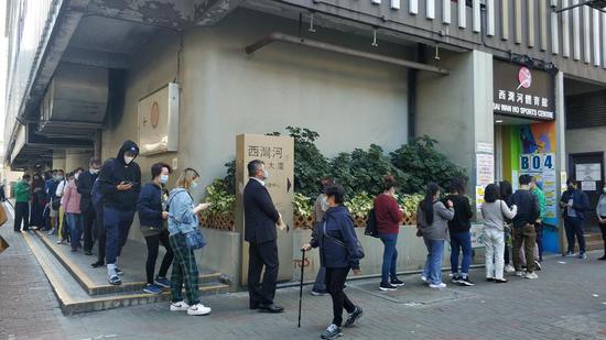 Residents line up to take their COVID-19 vaccine shot at the Sai Wan Ho Sports Centre in Sai Wan Ho, Hong Kong on Jan 4, 2022. (PHOTO PROVIDED TO CHINA DAILY)