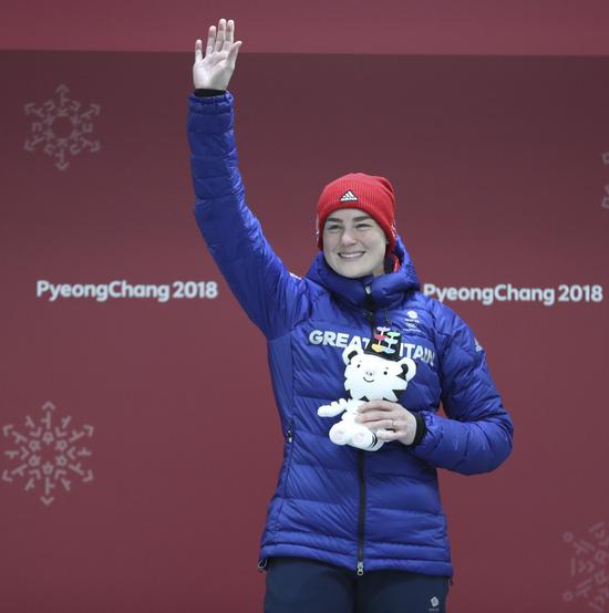 Britain's Laura Deas celebrates during venue ceremony of women event of skeleton at 2018 Winter Olympic Games at Olympic Sliding Centre, PyeongChang, South Korea, Feb. 17, 2018. Laura Deas claimed bronze in a time of 3:27.90. (Xinhua/Bai Xuefei)