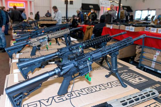 Guns are on display at the Dallas Gun Show in Parker, a suburban city of Dallas, Texas, the United States, Jan. 22, 2022. (Photo by Lin Li/Xinhua)