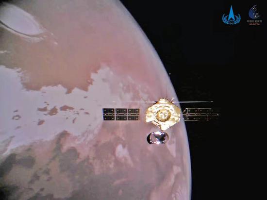 Photo released on Jan. 1, 2022 by the China National Space Administration (CNSA) shows the group photo of the orbiter and Mars.  (CNSA/Handout via Xinhua)