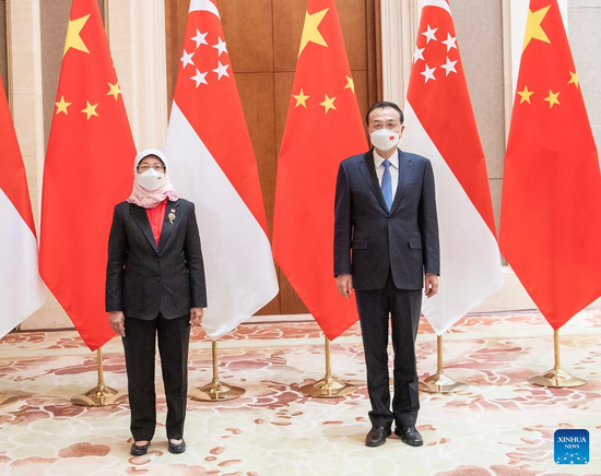 Chinese Premier Li Keqiang meets with visiting Singaporean President Halimah Yacob, who came to China for the opening ceremony of the Beijing 2022 Olympic Winter Games, at the Diaoyutai State Guesthouse in Beijing, capital of China, Feb. 5, 2022. (Xinhua/Li Tao)