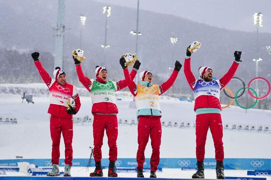 Athletes of ROC celebrate during the flower ceremony of cross-country skiing men's 4x10 km relay of the Beijing Winter Olympics at the National Cross-Country Skiing Centre in Zhangjiakou, north China's Hebei Province, Feb. 13, 2022. (Xinhua/Mu Yu)