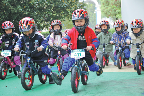 Children at a kindergarten in Lianyungang, Jiangsu province, use balance bikes to exercise in last October. (China Daily/Wang Chun)