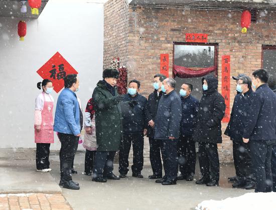 President Xi Jinping, who is also general secretary of the Communist Party of China Central Committee, talks on Wednesday with villagers in Huozhou, Shanxi province, during his inspection of the province ahead of Chinese Lunar New Year, which falls on Tuesday. (Xinhua/Xie Huanchi)