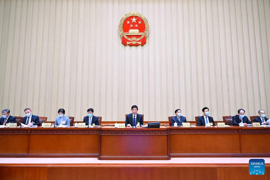 Li Zhanshu, chairman of the National People's Congress (NPC) Standing Committee, presides over the first plenary meeting of the 33rd session of the 13th NPC Standing Committee at the Great Hall of the People in Beijing, capital of China, Feb. 27, 2022. (Xinhua/Zhang Ling)