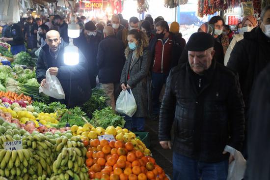 People shop at a market in Ankara, Turkey, March 3, 2022. (Photo by Mustafa Kaya/Xinhua)