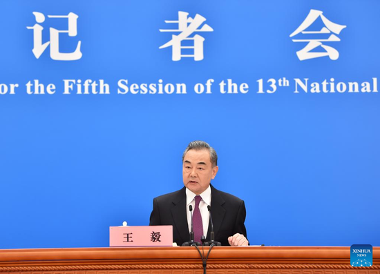 Chinese State Councilor and Foreign Minister Wang Yi attends a press conference on China's foreign policy and foreign relations via video link on the sidelines of the fifth session of the 13th National People's Congress (NPC) at the 